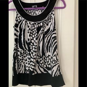 Sleeveless black & white round neck halter blouse.